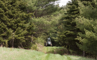 tractor driving through forest