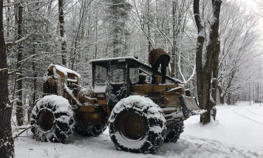 Man on bulldozer in winter