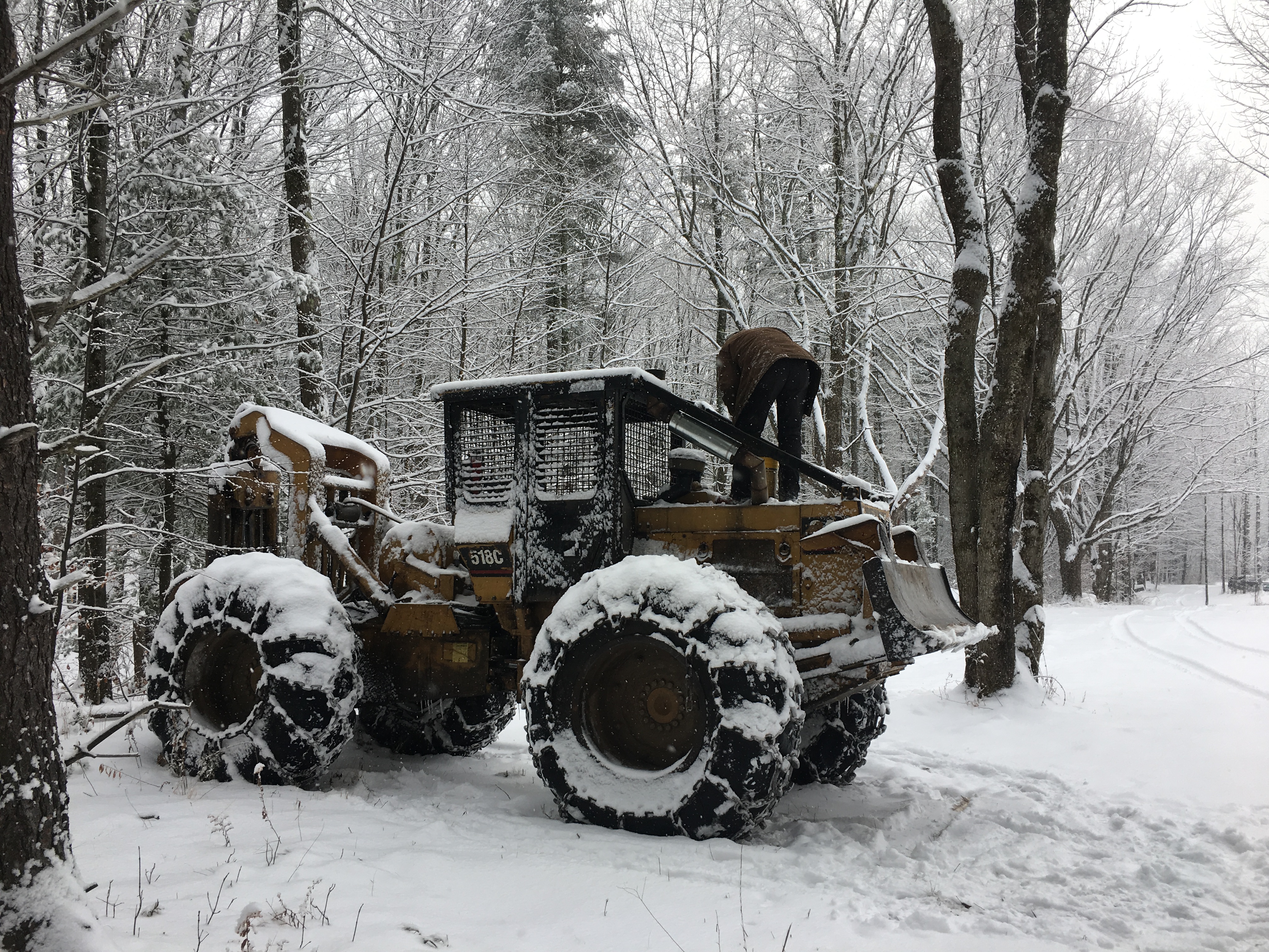 Man on bulldozer in winter