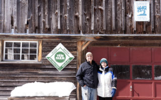 Couple With Tree Farm Sign