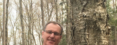 Commissioner michael snyder holding copy of Woods Whys